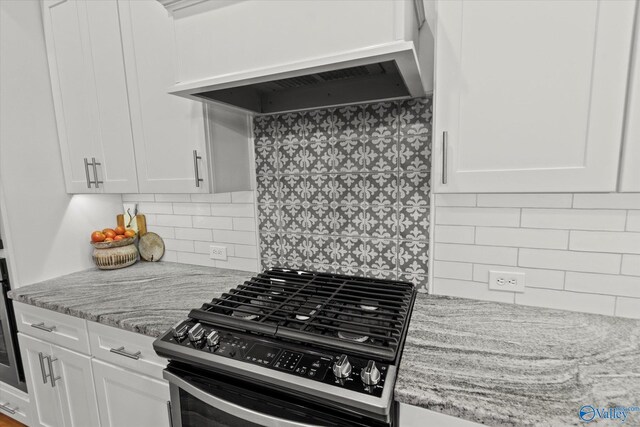 22424 Cantera Dr, Athens, AL 35613 - kitchen featuring stainless steel gas stove, custom range hood, white cabinets, and light stone counters