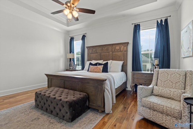 22424 Cantera Dr, Athens, AL 35613 - bedroom featuring a raised ceiling, multiple windows, wood finished floors, and baseboards