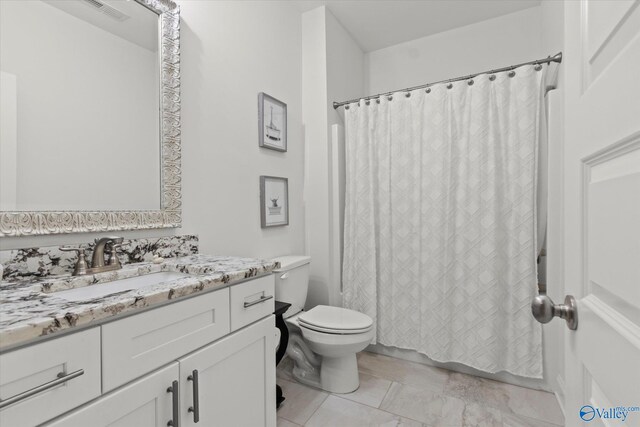 22424 Cantera Dr, Athens, AL 35613 - bathroom featuring toilet, vanity, marble look tile flooring, and a shower with curtain