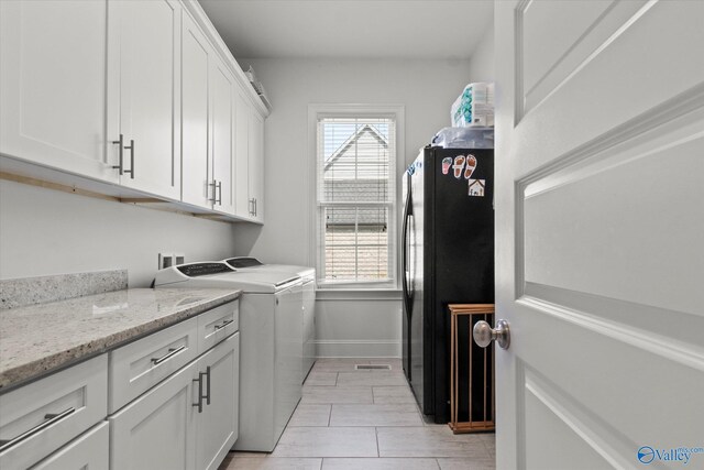 22424 Cantera Dr, Athens, AL 35613 - laundry area featuring washing machine and dryer, cabinet space, and baseboards