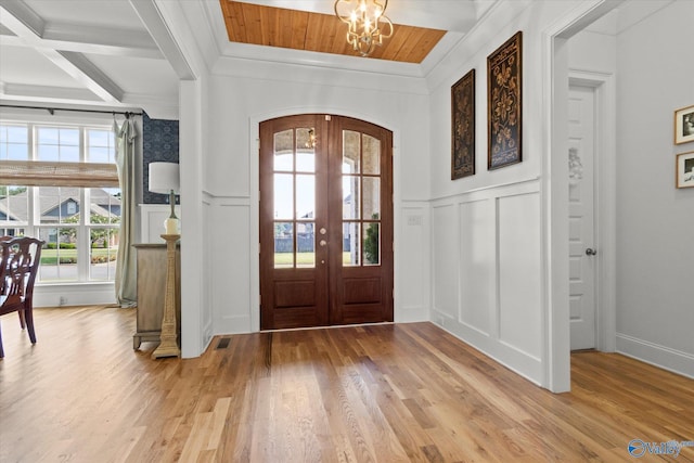 22424 Cantera Dr, Athens, AL 35613 - entrance foyer featuring a decorative wall, beam ceiling, a chandelier, light wood finished floors, and french doors