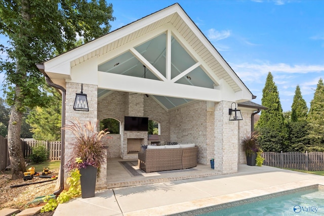 22424 Cantera Dr, Athens, AL 35613 - back of property featuring an outdoor living space with a fireplace, stone siding, a patio, and fence