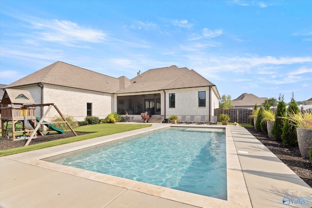 22424 Cantera Dr, Athens, AL 35613 - view of swimming pool featuring fence, a playground, a sunroom, and a patio