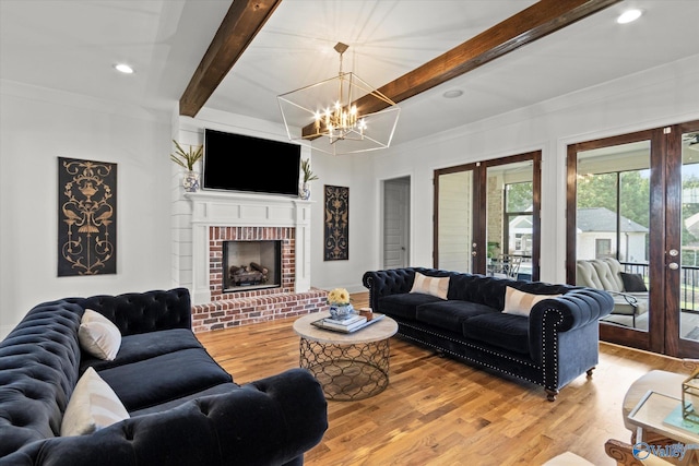 22424 Cantera Dr, Athens, AL 35613 - living area featuring french doors, beam ceiling, a chandelier, light wood-style floors, and a fireplace