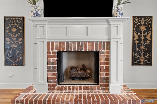 22424 Cantera Dr, Athens, AL 35613 - detailed view of a brick fireplace, baseboards, and wood finished floors