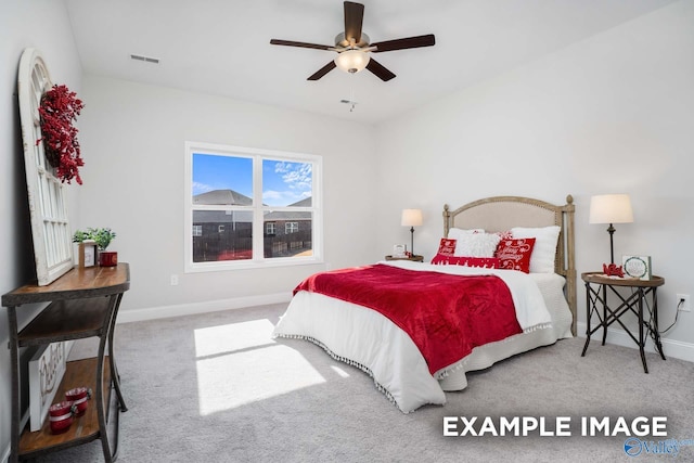 carpeted bedroom with a ceiling fan, visible vents, and baseboards