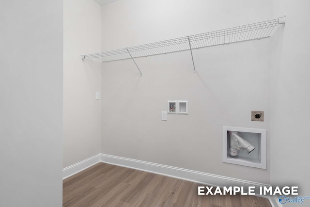 clothes washing area with laundry area, baseboards, wood finished floors, hookup for a washing machine, and electric dryer hookup