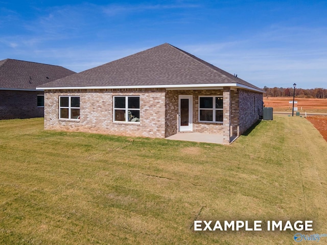 back of property with a lawn, roof with shingles, central air condition unit, a patio area, and brick siding