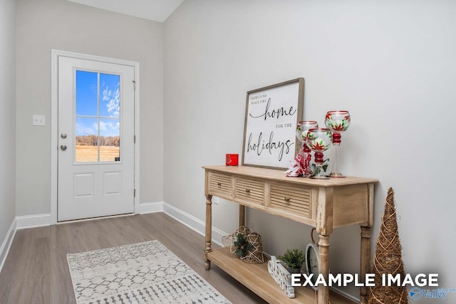 entryway with wood finished floors and baseboards