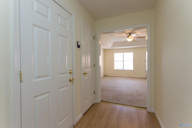 143 Laredo Cir, Huntsville, AL 35811 - corridor featuring light wood-style flooring, baseboards, and light colored carpet