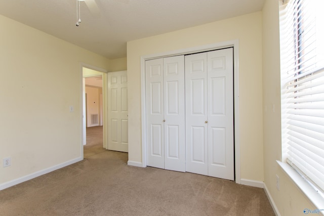 143 Laredo Cir, Huntsville, AL 35811 - unfurnished bedroom featuring carpet, multiple windows, and a closet