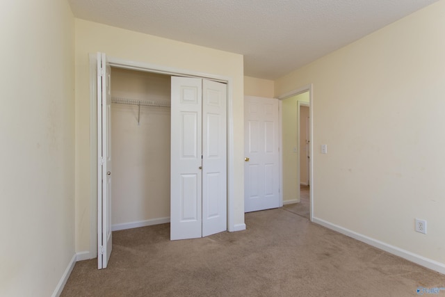 143 Laredo Cir, Huntsville, AL 35811 - unfurnished bedroom with carpet flooring, a closet, and baseboards