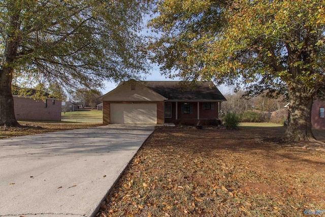143 Laredo Cir, Huntsville, AL 35811 - ranch-style home with an attached garage, concrete driveway, and covered porch
