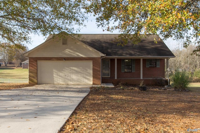 143 Laredo Cir, Huntsville, AL 35811 - single story home featuring brick siding, a garage, driveway, and covered porch