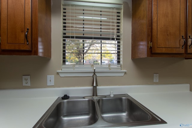 143 Laredo Cir, Huntsville, AL 35811 - kitchen featuring a sink, light countertops, and brown cabinetry