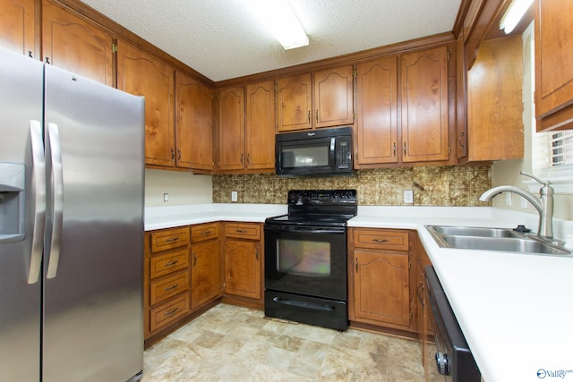 143 Laredo Cir, Huntsville, AL 35811 - kitchen featuring black appliances, a sink, brown cabinets, and a textured ceiling