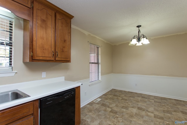 143 Laredo Cir, Huntsville, AL 35811 - kitchen with dishwasher, plenty of natural light, brown cabinetry, a textured ceiling, and hanging light fixtures
