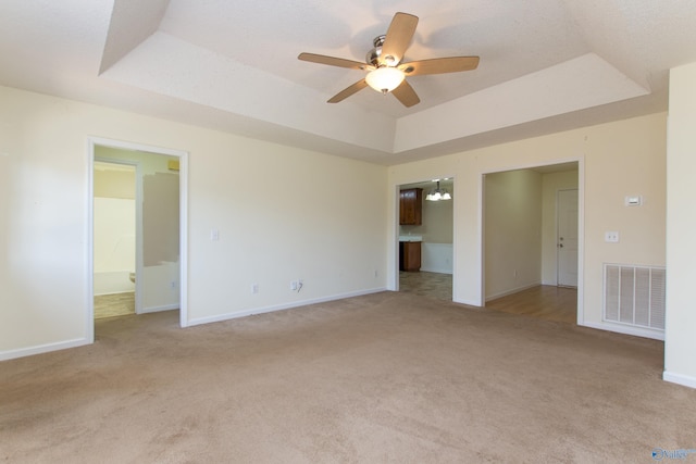 143 Laredo Cir, Huntsville, AL 35811 - unfurnished room featuring a tray ceiling, light colored carpet, a ceiling fan, and baseboards