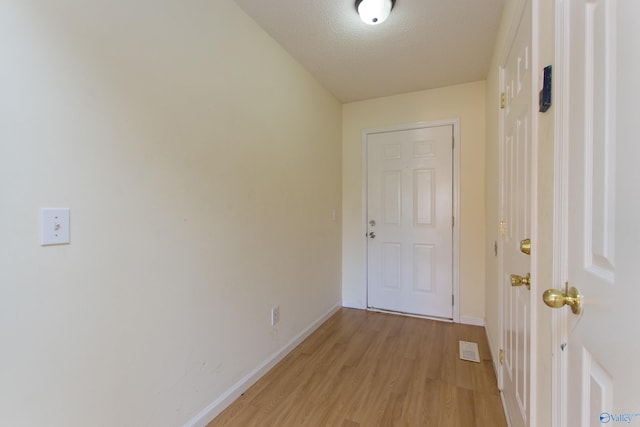 143 Laredo Cir, Huntsville, AL 35811 - hallway featuring light wood-type flooring, baseboards, and a textured ceiling