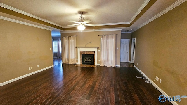 unfurnished living room featuring ornamental molding, a fireplace, wood finished floors, and baseboards