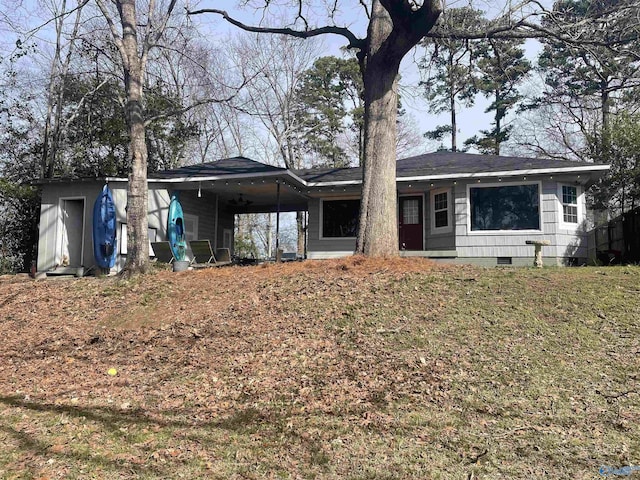 back of property featuring an attached carport and crawl space