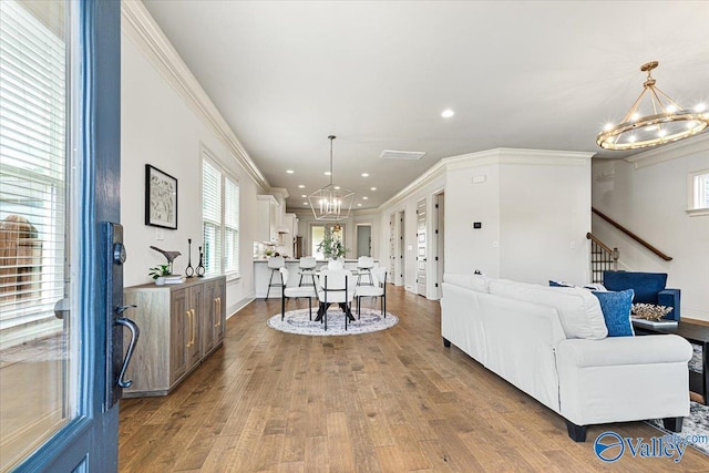 108 Napolean Ave, Madison, AL 35758 - living area featuring a chandelier, ornamental molding, recessed lighting, wood finished floors, and stairs
