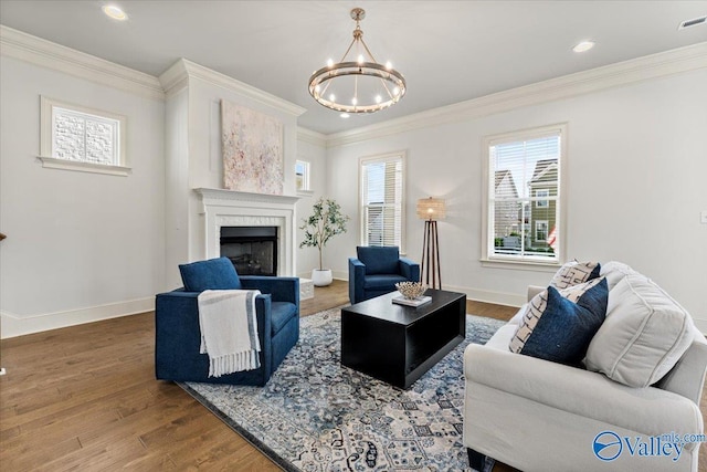 108 Napolean Ave, Madison, AL 35758 - living area with a chandelier, a high end fireplace, wood finished floors, crown molding, and baseboards