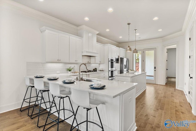 108 Napolean Ave, Madison, AL 35758 - kitchen with a sink, appliances with stainless steel finishes, a peninsula, a breakfast bar, and light countertops