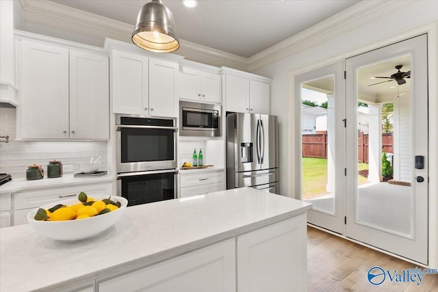 108 Napolean Ave, Madison, AL 35758 - kitchen featuring appliances with stainless steel finishes, plenty of natural light, white cabinetry, and ornamental molding