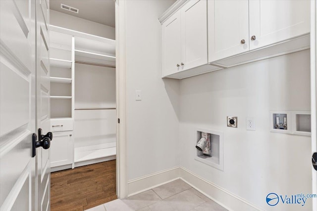 108 Napolean Ave, Madison, AL 35758 - washroom with hookup for an electric dryer, washer hookup, cabinet space, baseboards, and light tile patterned floors