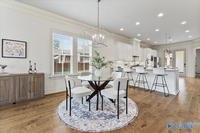 108 Napolean Ave, Madison, AL 35758 - dining room featuring ornamental molding, a chandelier, dark wood-type flooring, healthy amount of natural light, and recessed lighting