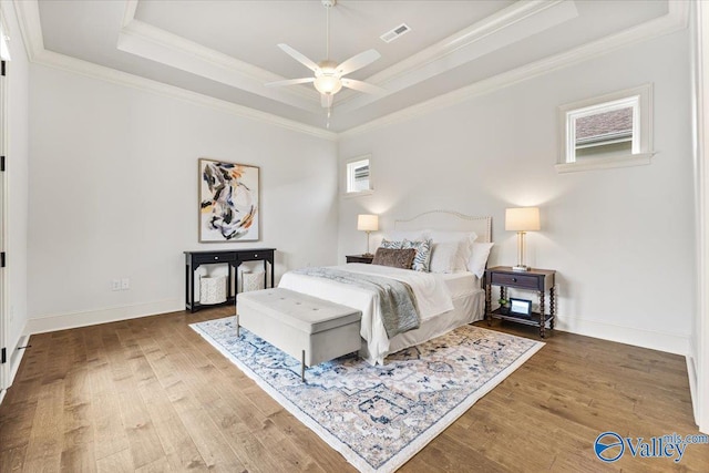 108 Napolean Ave, Madison, AL 35758 - bedroom featuring a raised ceiling, wood finished floors, ornamental molding, and baseboards