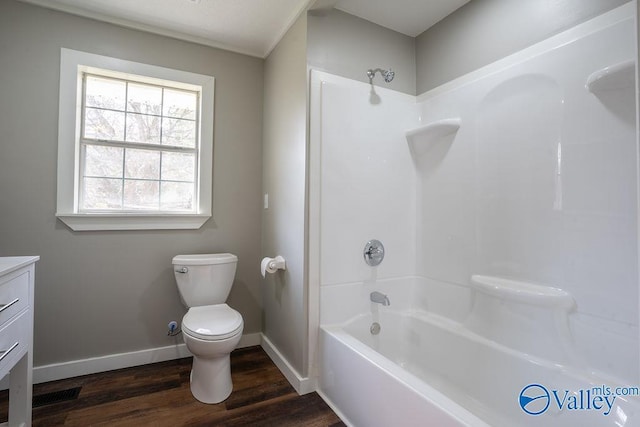 full bathroom with vanity, hardwood / wood-style flooring, toilet, and  shower combination