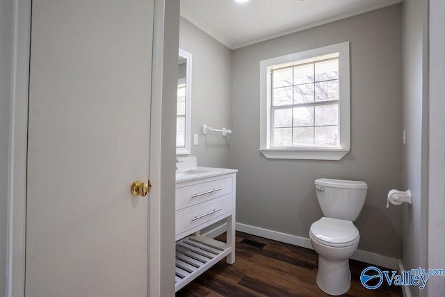 bathroom featuring hardwood / wood-style flooring, vanity, and toilet