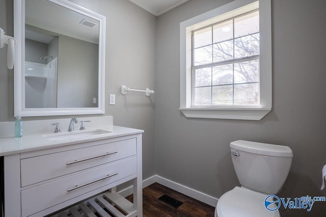 bathroom featuring hardwood / wood-style floors, vanity, and toilet