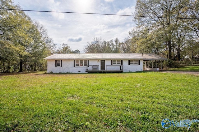 single story home with a carport, a deck, and a front lawn