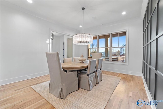 dining area featuring a notable chandelier, recessed lighting, wood finished floors, baseboards, and crown molding