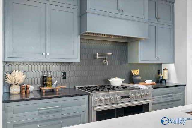 kitchen with range with two ovens, custom exhaust hood, and tasteful backsplash