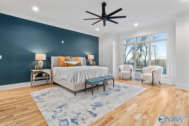 bedroom featuring an accent wall, baseboards, wood finished floors, and recessed lighting