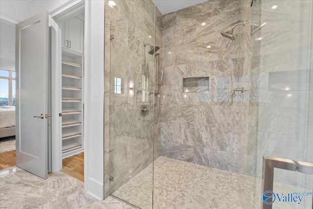 ensuite bathroom with a tile shower and ensuite bath