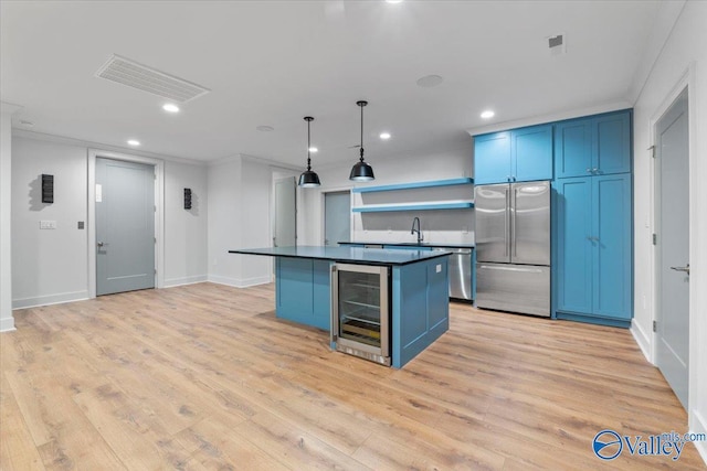 kitchen with stainless steel appliances, wine cooler, dark countertops, and blue cabinets