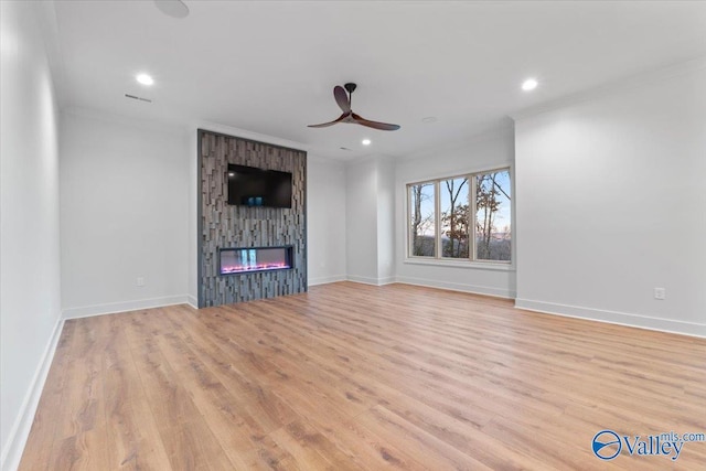 unfurnished living room with ceiling fan, light wood-style flooring, recessed lighting, a large fireplace, and baseboards