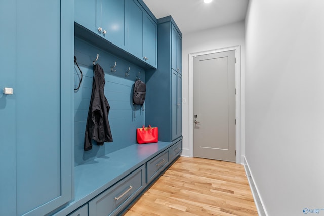 mudroom with light wood finished floors and baseboards