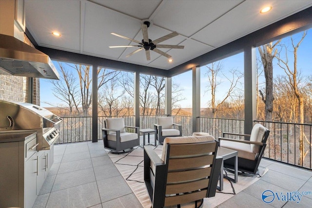 view of patio with ceiling fan, an outdoor living space, exterior kitchen, and grilling area