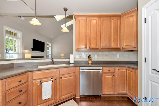 kitchen with a sink, dark countertops, backsplash, and stainless steel dishwasher