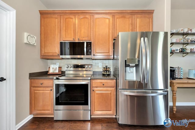 kitchen with stainless steel appliances, dark countertops, and tasteful backsplash