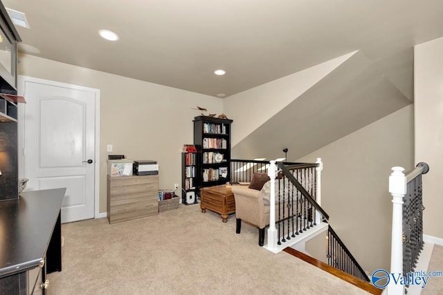 sitting room with recessed lighting, carpet, baseboards, and an upstairs landing