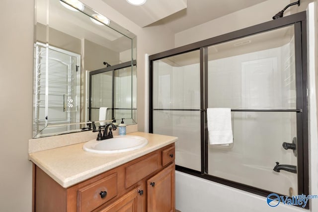 full bathroom with vanity and bath / shower combo with glass door