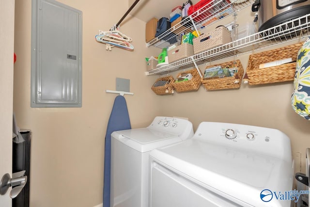 clothes washing area with laundry area, washing machine and dryer, and electric panel