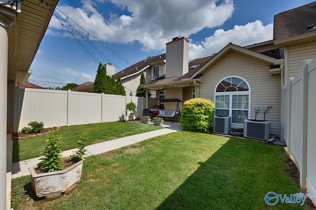 view of yard with a patio, a fenced backyard, and central air condition unit